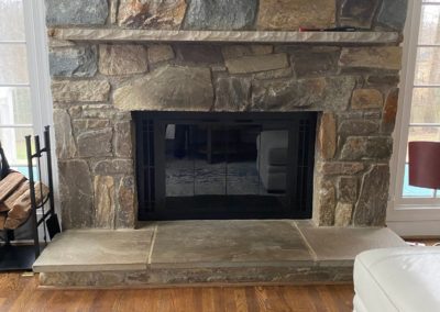 updated fireplace door with stone surround after