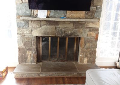 updated fireplace door with stone surround before